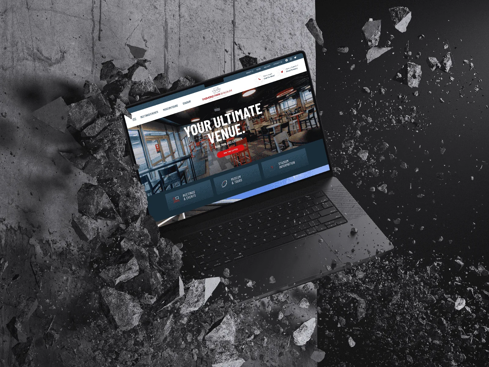 Website on laptop breaking concrete, showcasing website design.